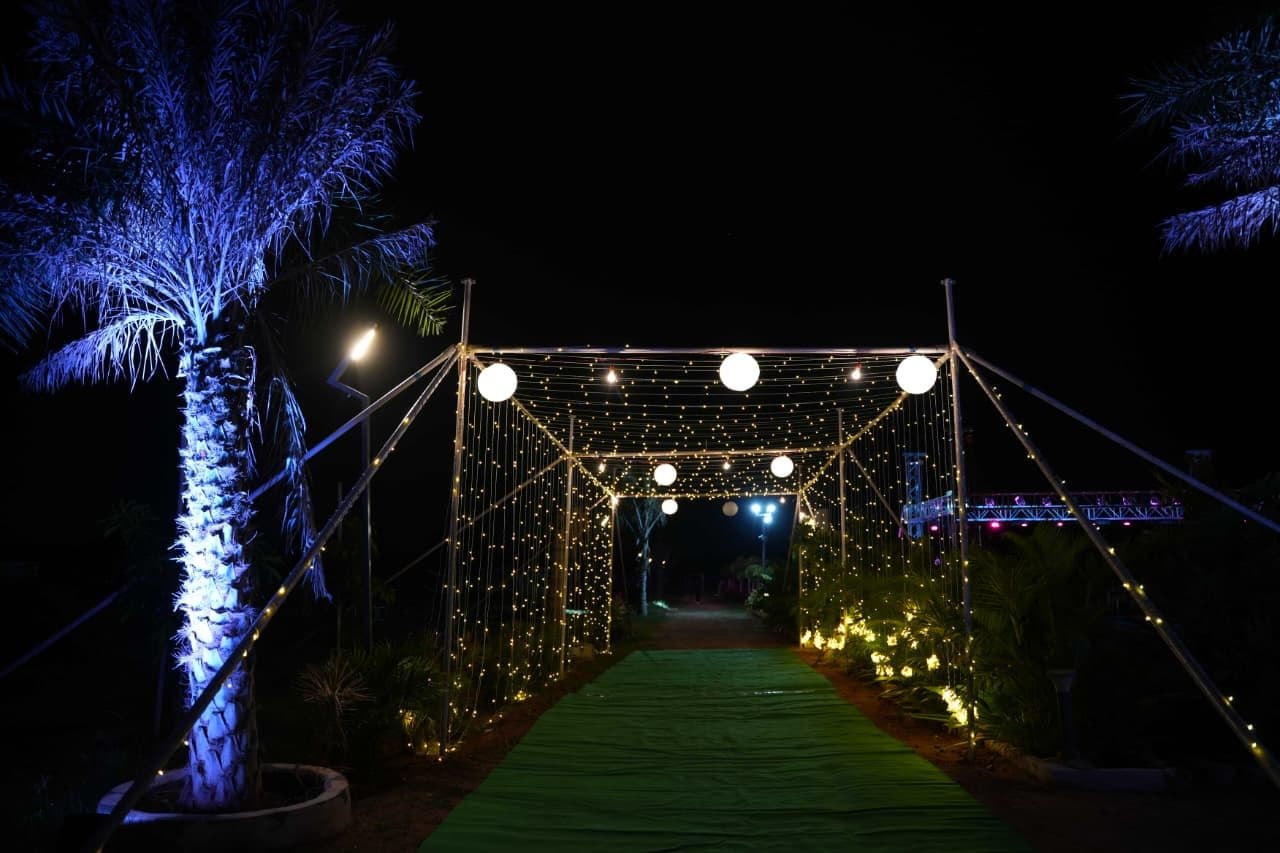 Event entrance walkway lit with strings of warm lights