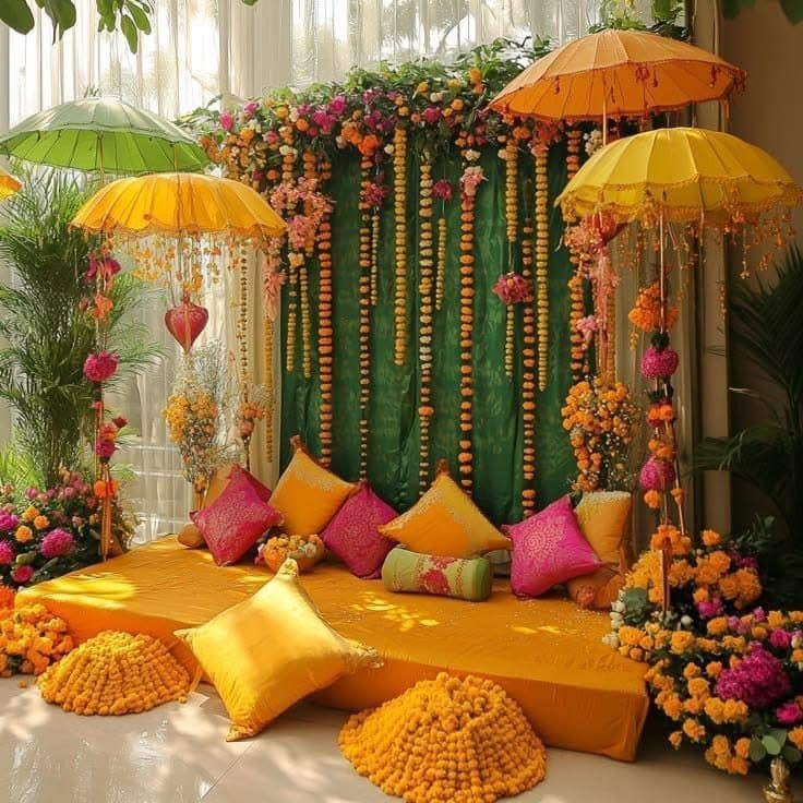 Haldi seating with parasols, garlands and marigold accents