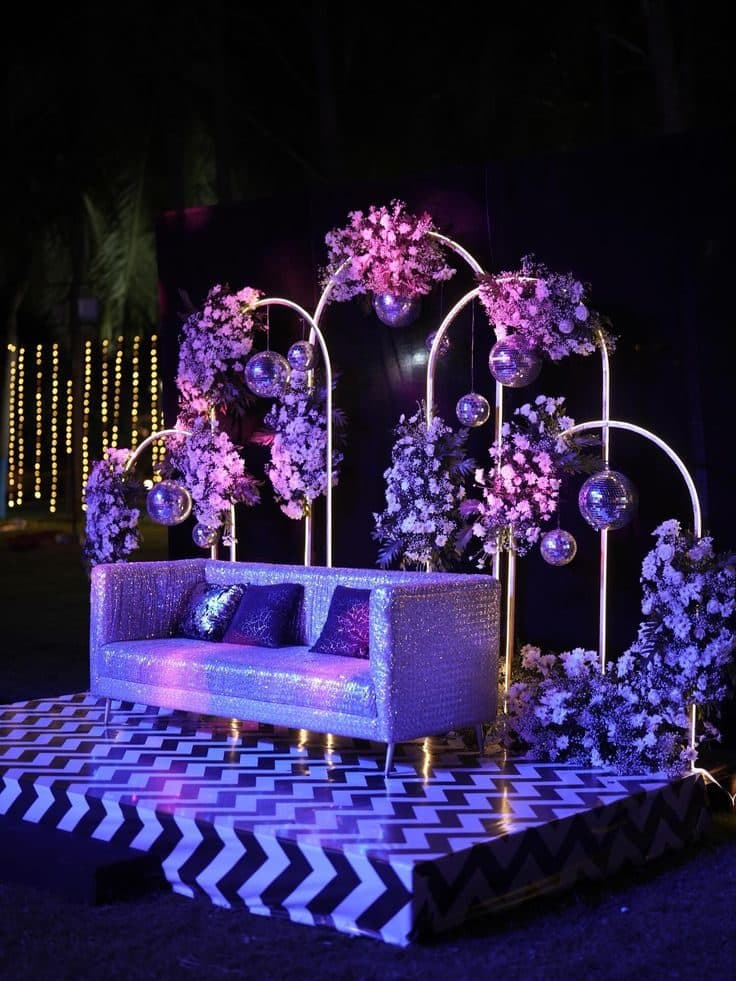 Sangeet lounge with lilac florals and mirrored seating